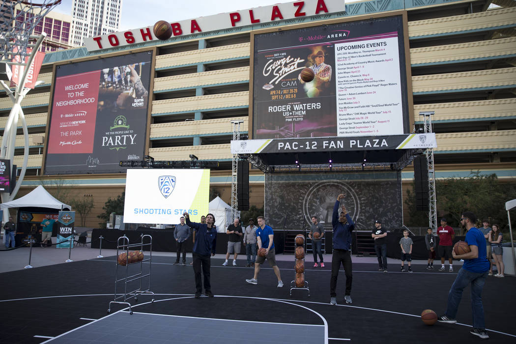 People play during a basketball challenge at Toshiba Plaza outside of T-Mobile Arena during the Pac-12 Men's Basketball Tournament on Wednesday, March 8, 2017, in Las Vegas. (Erik Verduzco/Las Veg ...