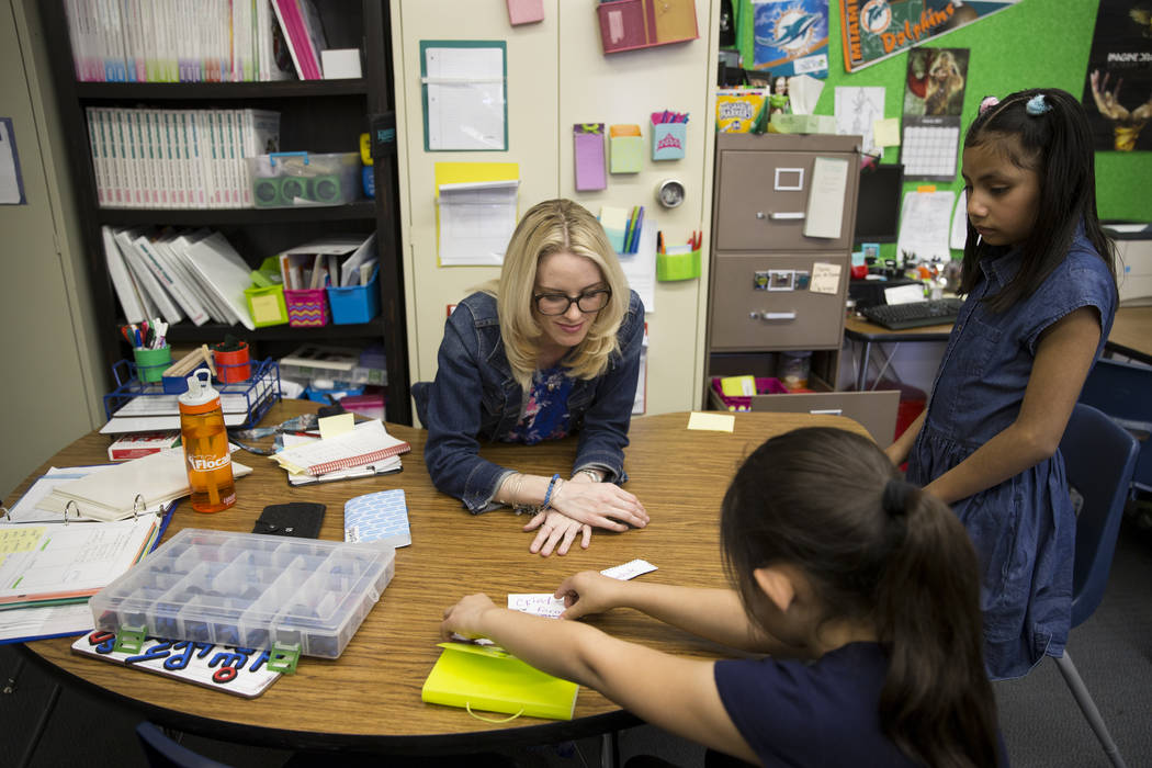 Growth analyst teacher Sara Boucher works on the reading and spelling skills of third grade student Jalessa Rojo, center, and Jacqueline Martinez at Wynn Elementary School on Thursday, March 9, 20 ...