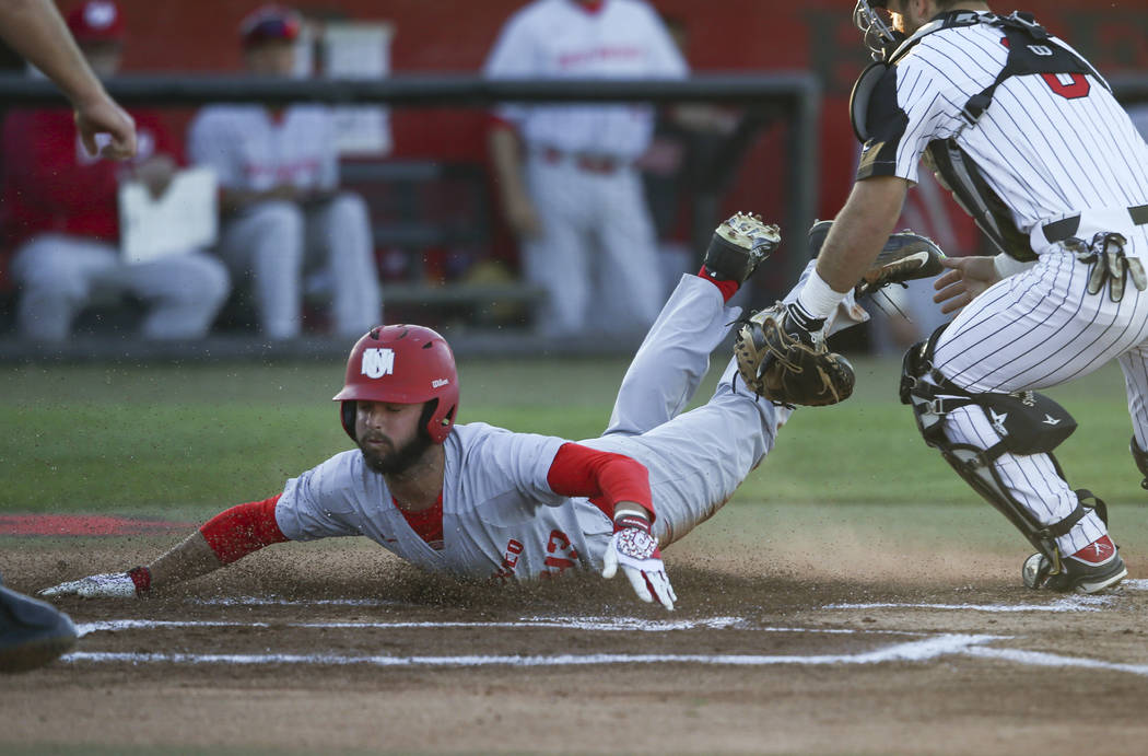 New Mexico outfielder Danny Collier (43) scores a run past UNLV catcher Payton Squier (6) during a baseball game at Wilson Stadium in Las Vegas on Friday, March 24, 2017. (Chase Stevens/Las Vegas ...