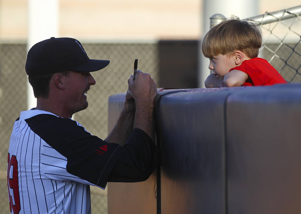 UNLV pitcher Connor Clark (39) signs a ball for Benjamin Hughe, 4, before a baseball game against New Mexico at Wilson Stadium in Las Vegas on Friday, March 24, 2017. (Chase Stevens/Las Vegas Revi ...