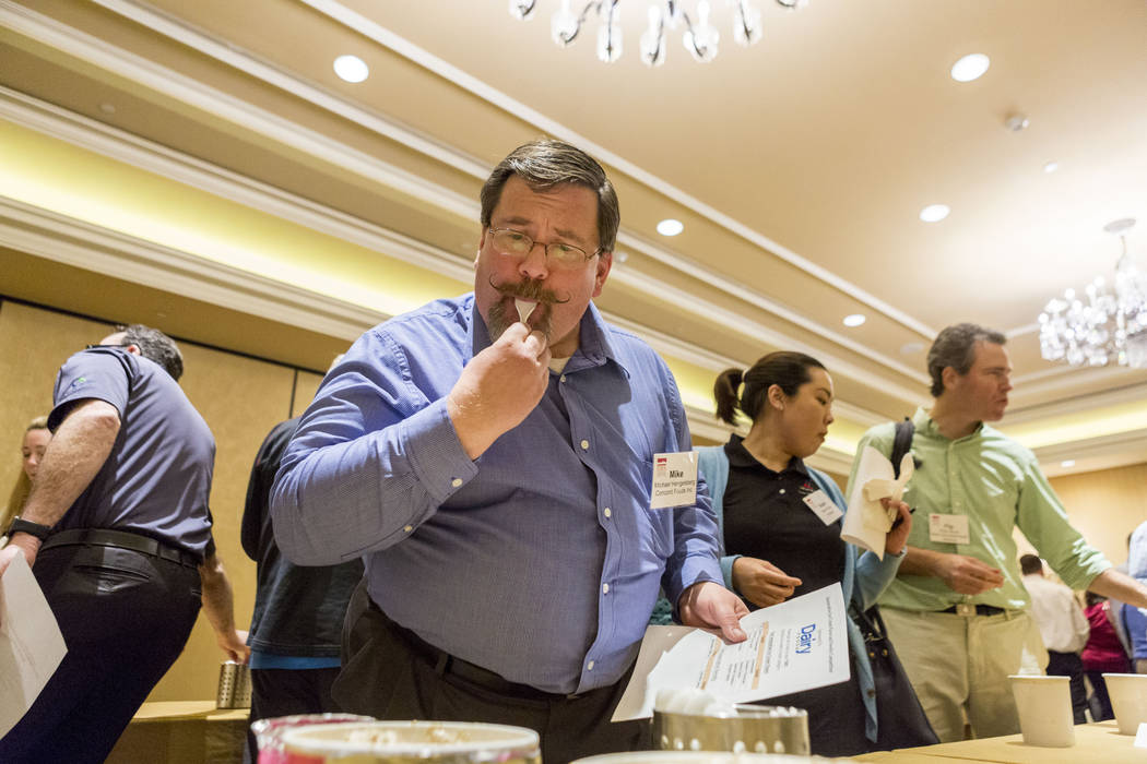 Michael Hengelsberg, attendee of the Ice Cream Technology Conference, samples an ice cream flavor apart of an innovative flavor contest during the convention at the Hilton Lake Las Vegas Resort &a ...