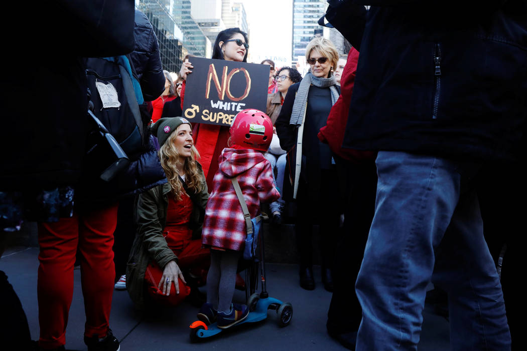 A young girl talks with her mother as they take part in a 'Day Without a Woman' march on International Women's Day in New York, U.S., March 8, 2017. (Lucas Jackson/Reuters)