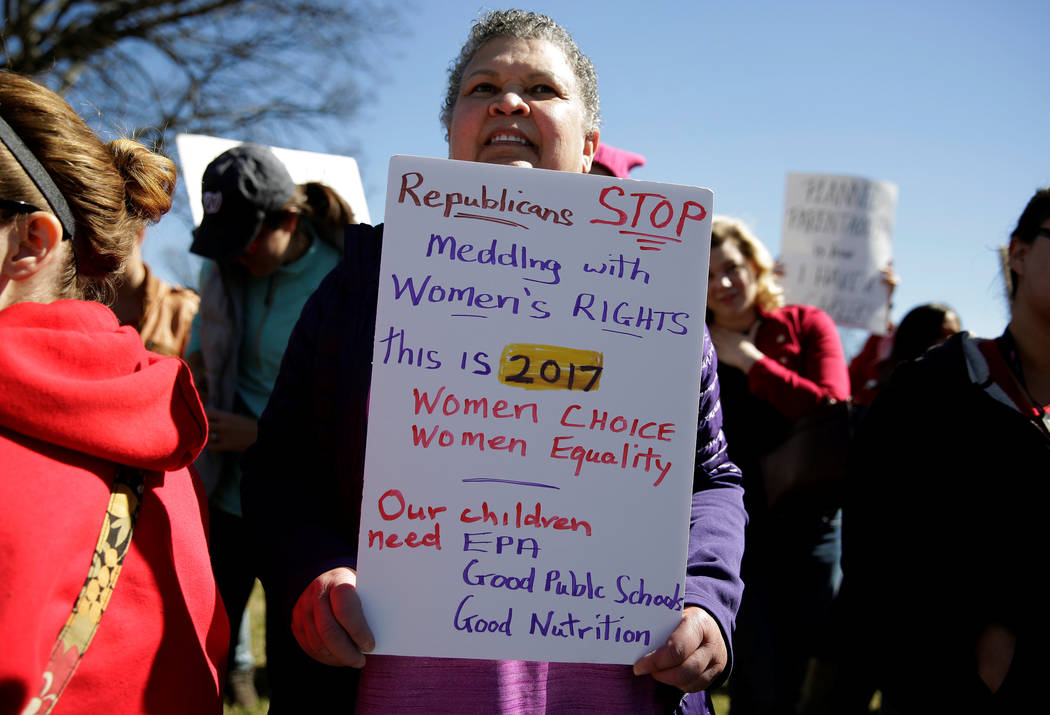 Supporters hold up signs during the "Day Without a Woman" on International Women's Day at the U.S. Capitol in Washington, U.S., March 8, 2017. (Joshua Roberts/Reuters)