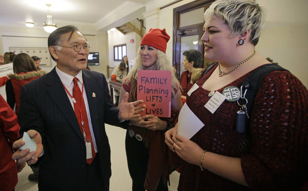 Sen. Brian Shiozawa, R-Salt Lake, speaks with Tali Bruce, center, and Kat Kellermeyer, right, outside the Senate chambers during a Day Without a Woman protest to remind legislators they're closely ...