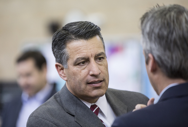 Nevada Gov. Brain Sandoval interacts with the media during a press conference to announce that Democracy Prep Public Schools will assume school operations of Andre Agassi Preparatory Academy in th ...
