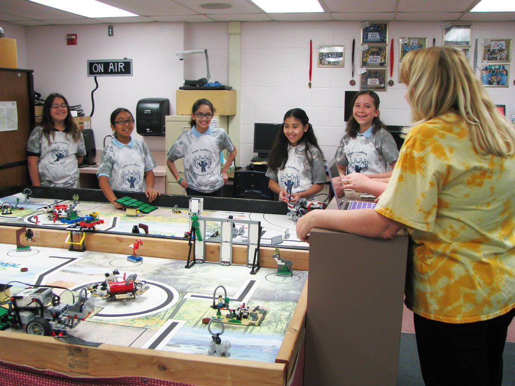 Coach Rachel Kuntz talks with members of the Jo Mackey Academy of Leadership and Global Communication through Technology Lego Leaders team on March 9, 2017. Kuntz has led the First Lego League Sou ...