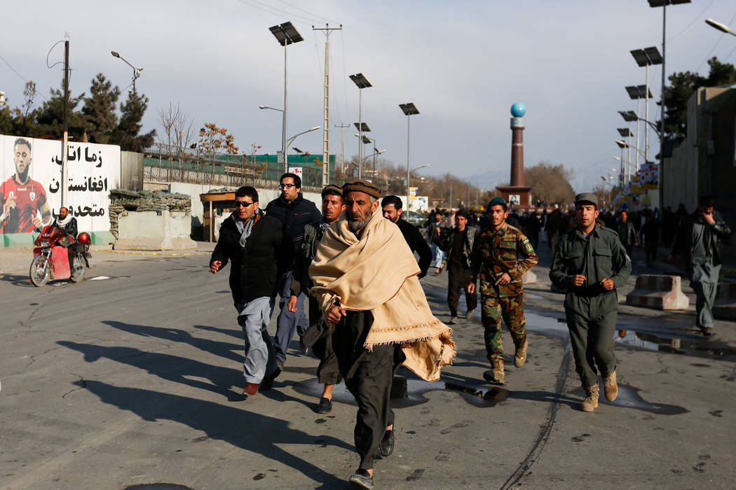 Afghan men walk toward a military hospital to see their relatives after blast and gunfire in Kabul, Afghanistan March 8, 2017. (Mohammad Ismail/Reuters)