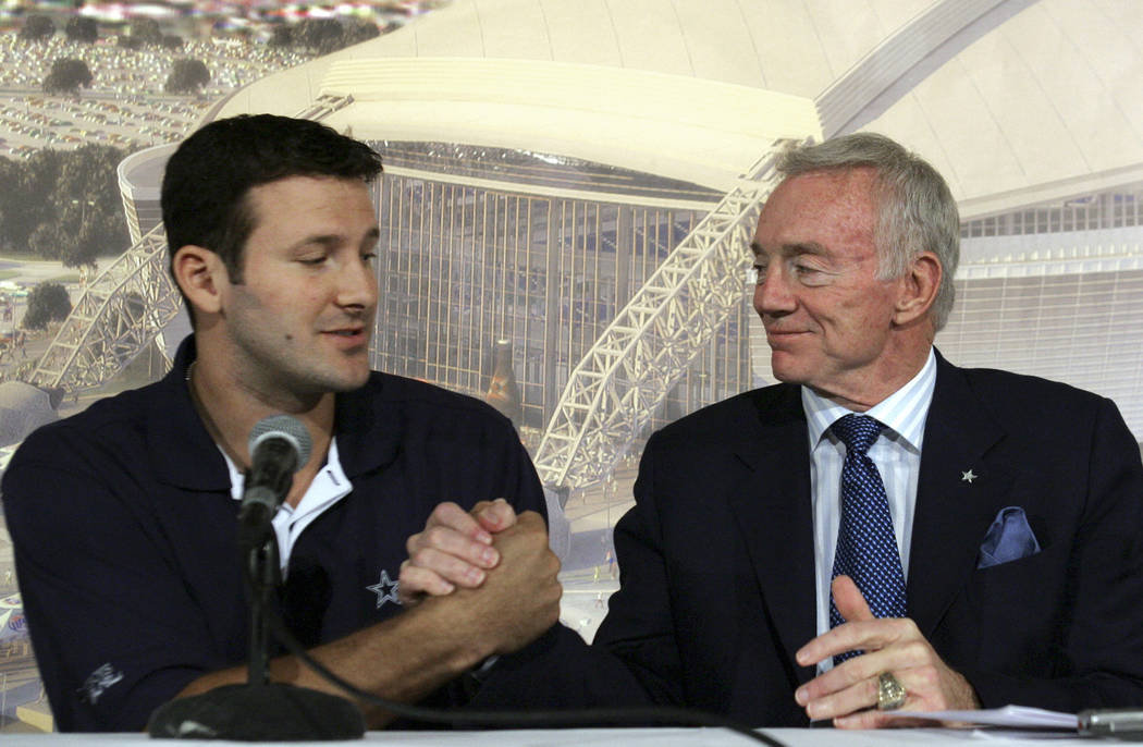 In this Oct. 30, 2007, file photo, Dallas Cowboys quarterback Tony Romo, left, shakes hands with team owner Jerry Jones during a news conference at team headquarters in Irving, Texas. (LM Otero, F ...