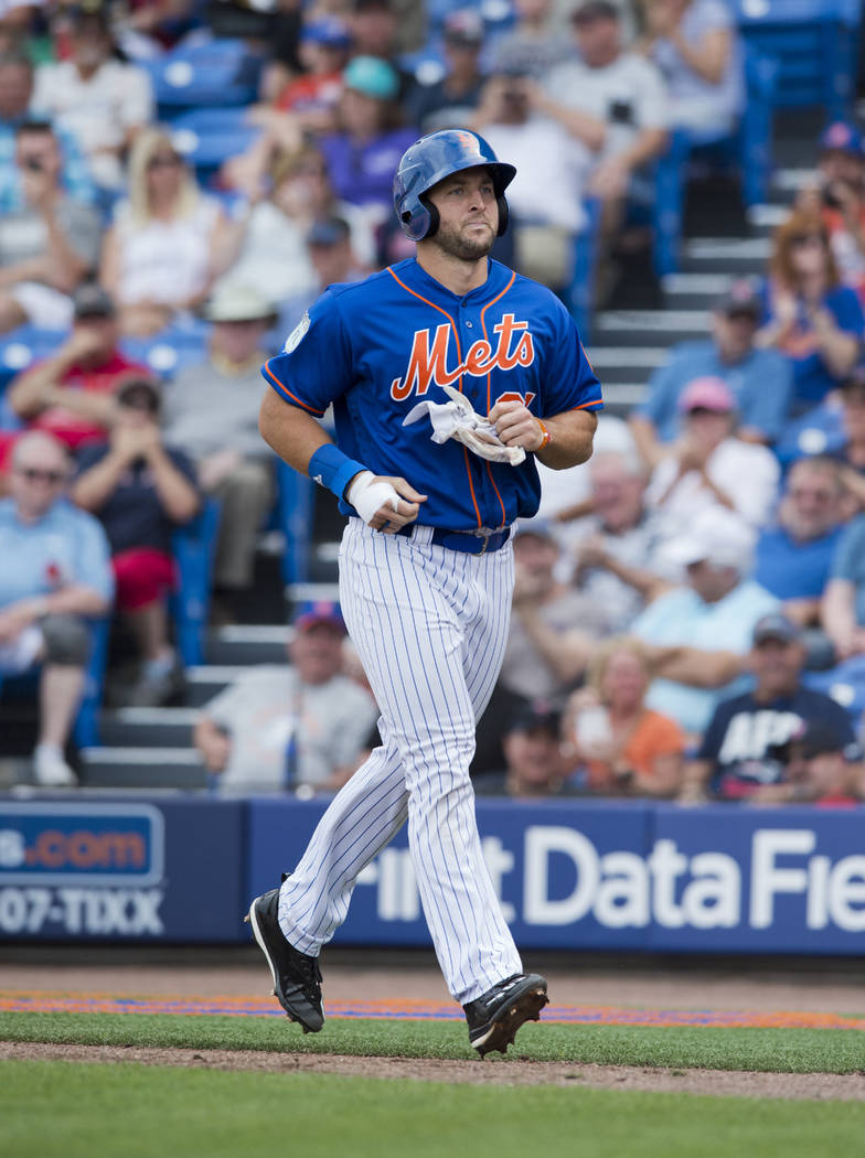 New York Mets designated hitter Tim Tebow makes his way back to the dugout in the fourth inning after he grounded into a double play during a spring training baseball game against the Boston Red S ...