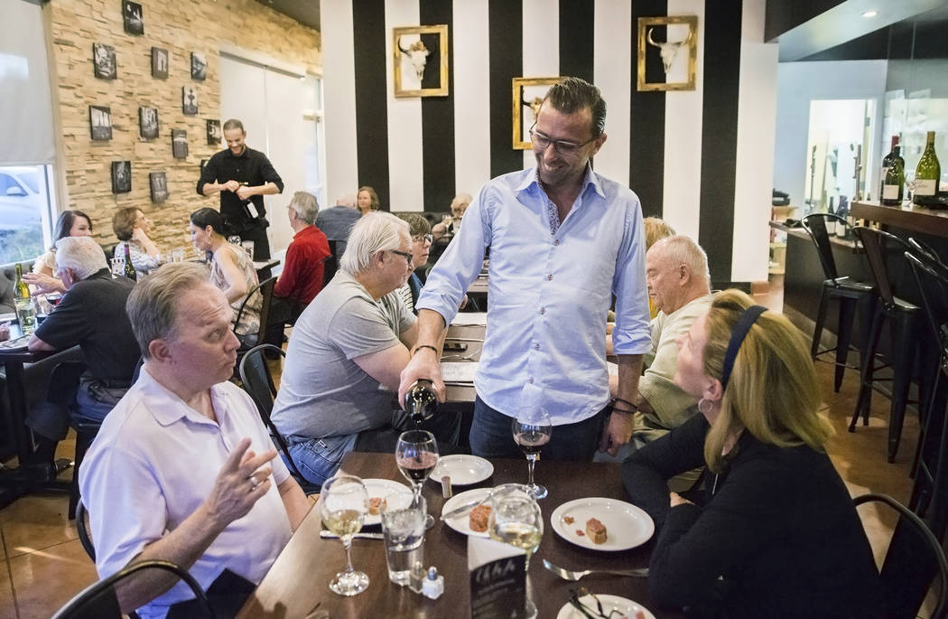 Owner/chef Richard Terzaghi pours wine for guests at Ohlala French Bistro on Wednesday, March 15, 2017, in Las Vegas. (Benjamin Hager/Las Vegas Review-Journal) @benjaminhphoto