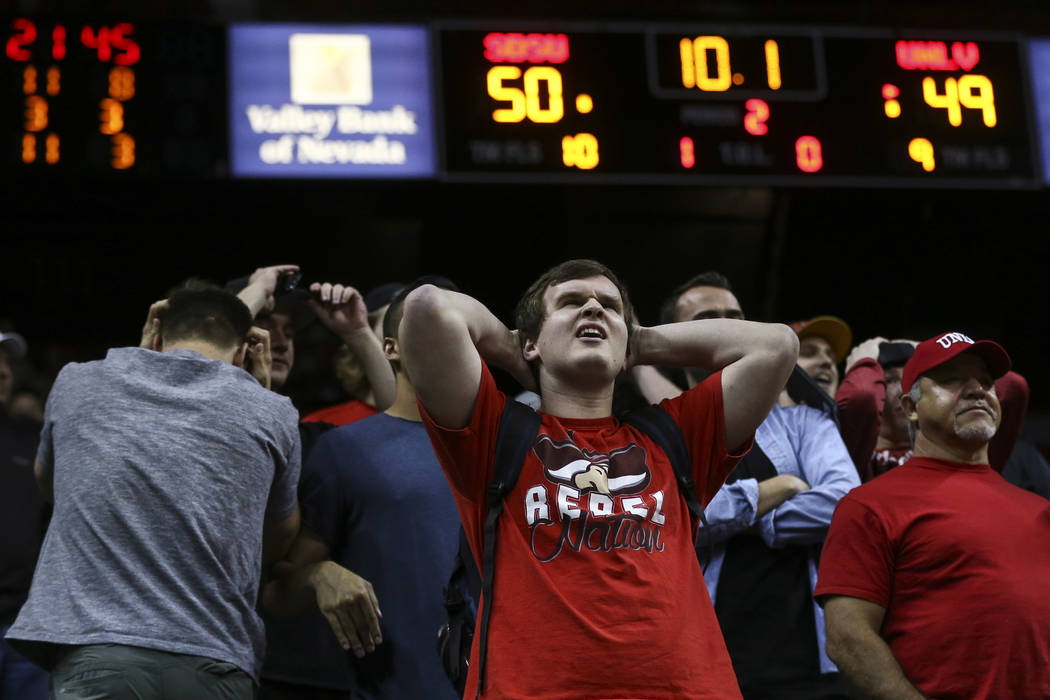 UNLV fans react as the team begins to trail San Diego State in the final moments of the second half during a Mountain West Conference tournament basketball game at the Thomas & Mack Center in  ...
