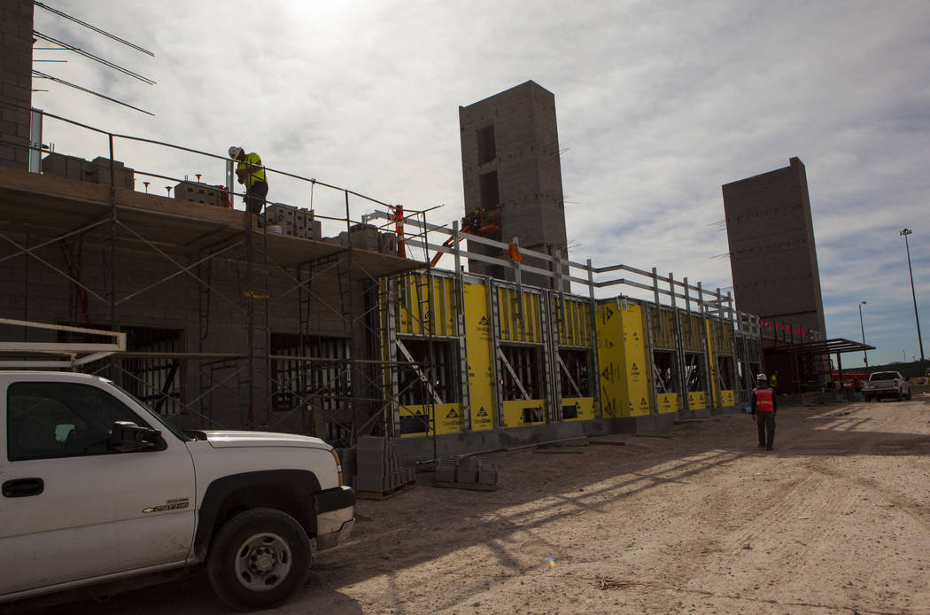 Construction workers    while working on the new 6-story hotel for the United Brotherhood of Carpenters union's training campus near McCarran International Airport in Las Vegas on Friday, March 10 ...