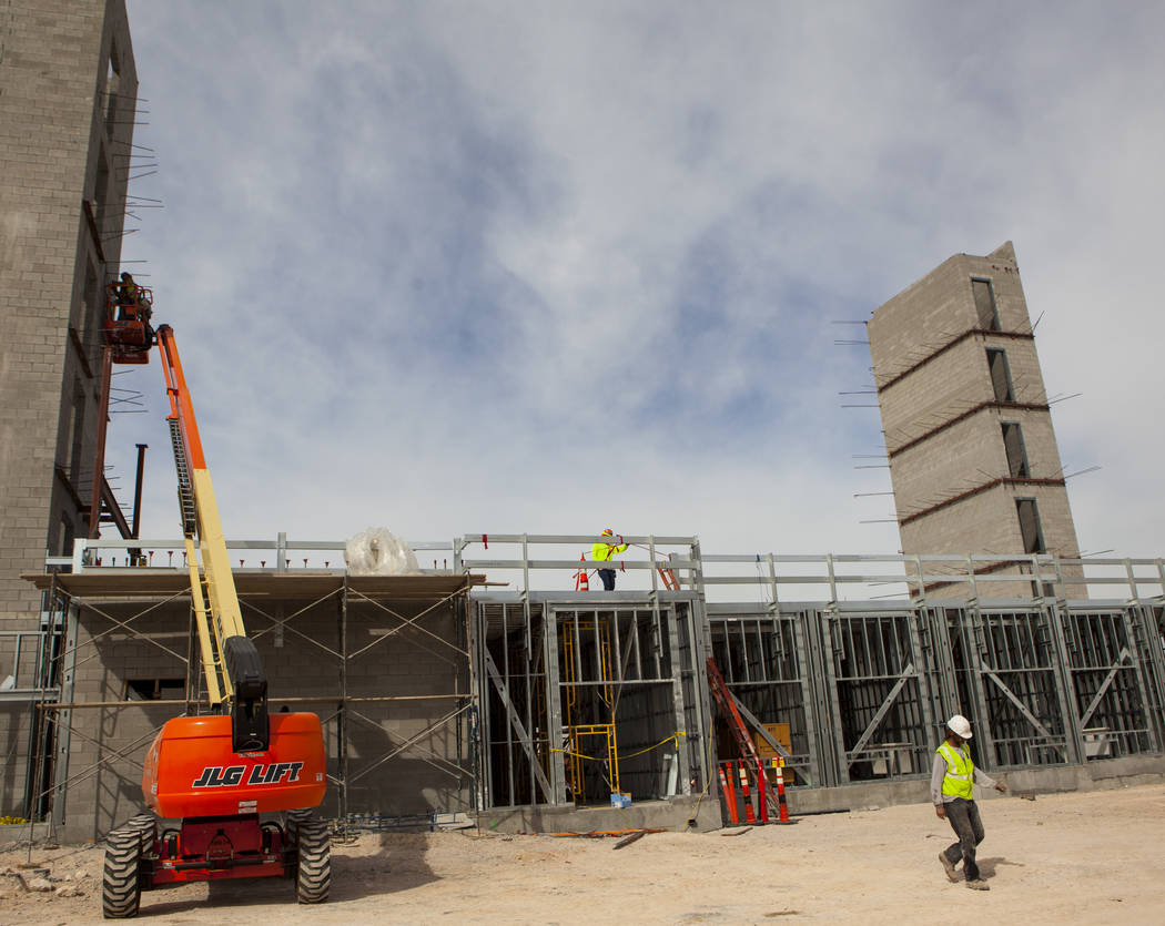 Construction workers use a forklift while working on the new 6-story hotel for the United Brotherhood of Carpenters union's training campus near McCarran International Airport in Las Vegas on Frid ...