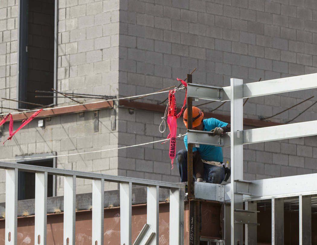 A construction worker works on the new 6-story hotel for the United Brotherhood of Carpenters union's training campus near McCarran International Airport in Las Vegas on Friday, March 10, 2017. Mi ...