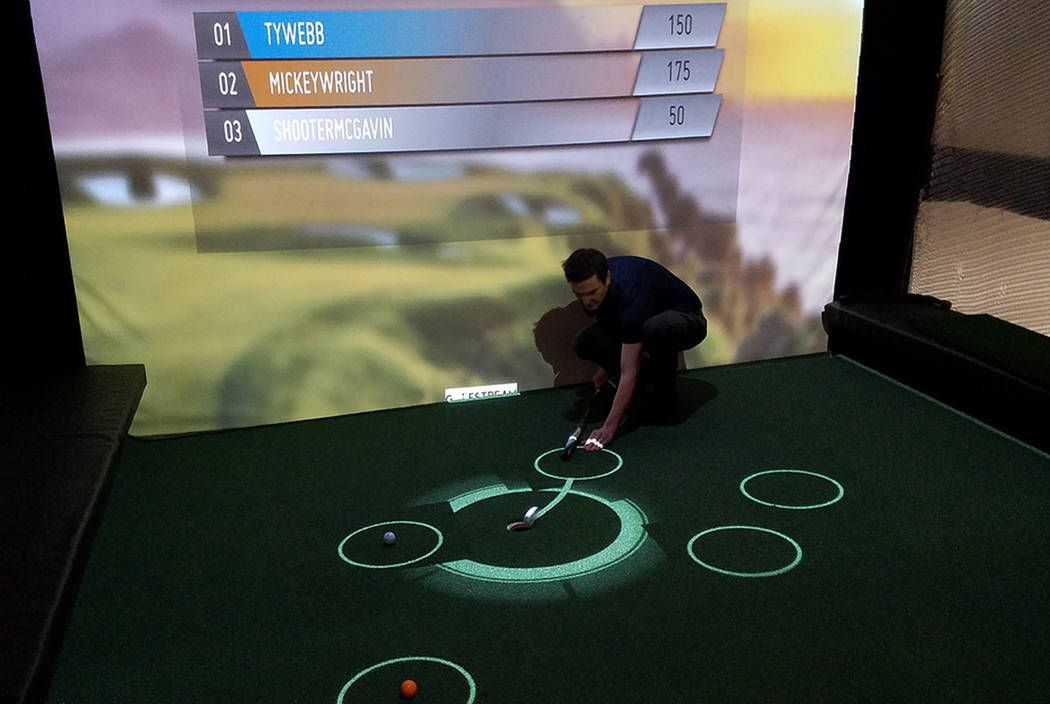 Golfstream co-founder and chief financial officer Darren Dummit channels Chevy Chases's "Caddyshack" character Ty Webb in a demonstration of a 30-second putting competition at the attraction's loc ...