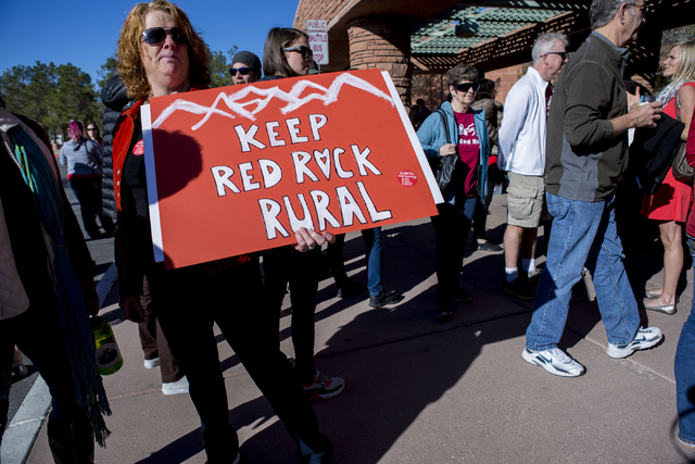 Susan Nicaise a supporter of Save Red Rock, holds a sign to protest the proposed development of 5,025 homes on Blue Diamond Hill at a press conference before the County Commissioners meeting Wedne ...