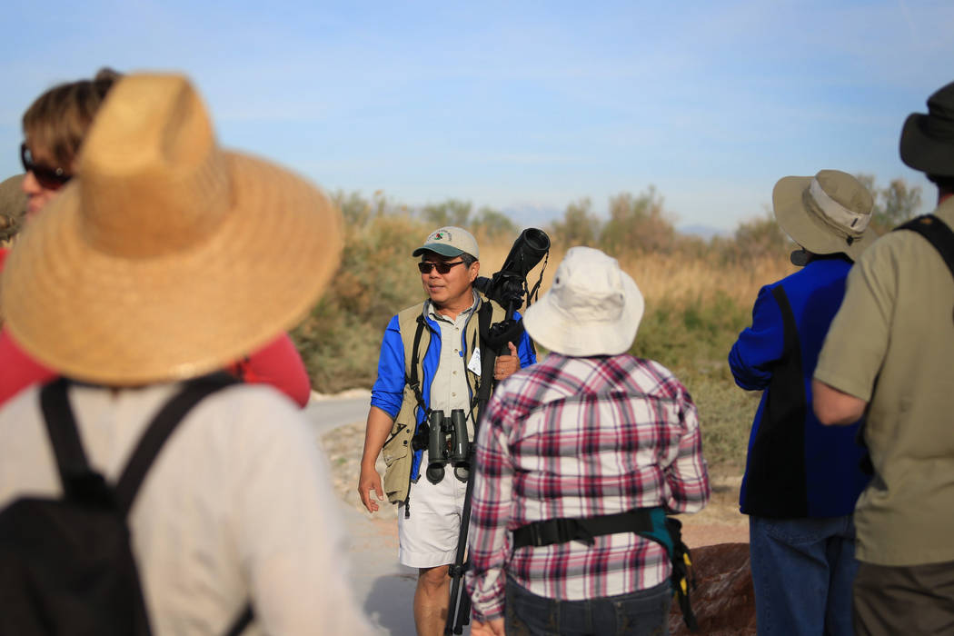 Doug Chang, center, president of the Red Rock Audubon society, leads a guided bird watching walk at Clark County Wetlands Park in Las Vegas on International Migratory Bird Day, Saturday, March 18, ...