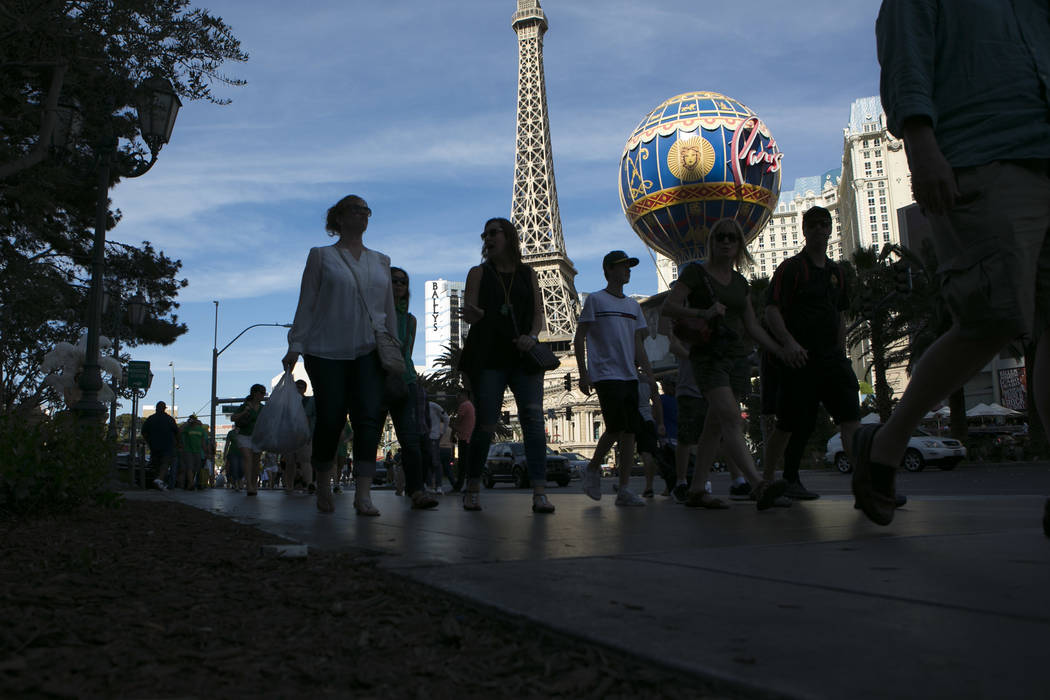 Pedestrians pass Paris Las Vegas' Eiffel Tower Experience on the Las Vegas Strip on Friday, March 17, 2017, in Las Vegas. (Bridget Bennett/Las Vegas Review-Journal) @bridgetkb