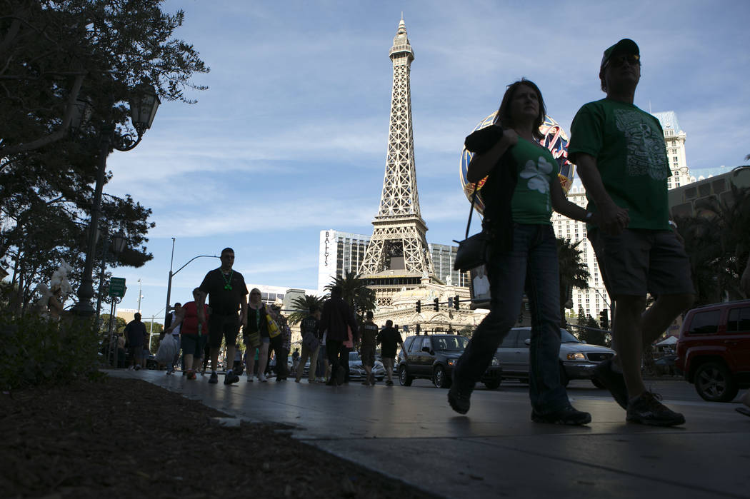 Pedestrians pass Paris Las Vegas' Eiffel Tower Experience on the Las Vegas Strip on Friday, March 17, 2017, in Las Vegas. (Bridget Bennett/Las Vegas Review-Journal) @bridgetkb