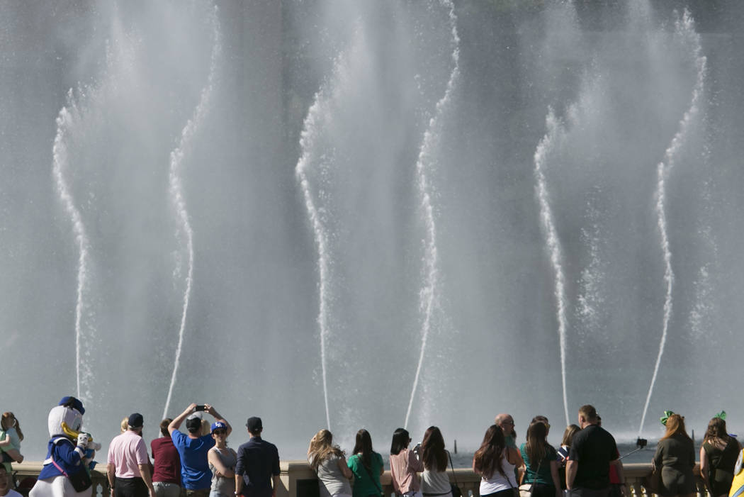 Pedestrians watch the Fountains of Bellagio on the Las Vegas Strip on Friday, March 17, 2017, in Las Vegas. (Bridget Bennett/Las Vegas Review-Journal) @bridgetkb
