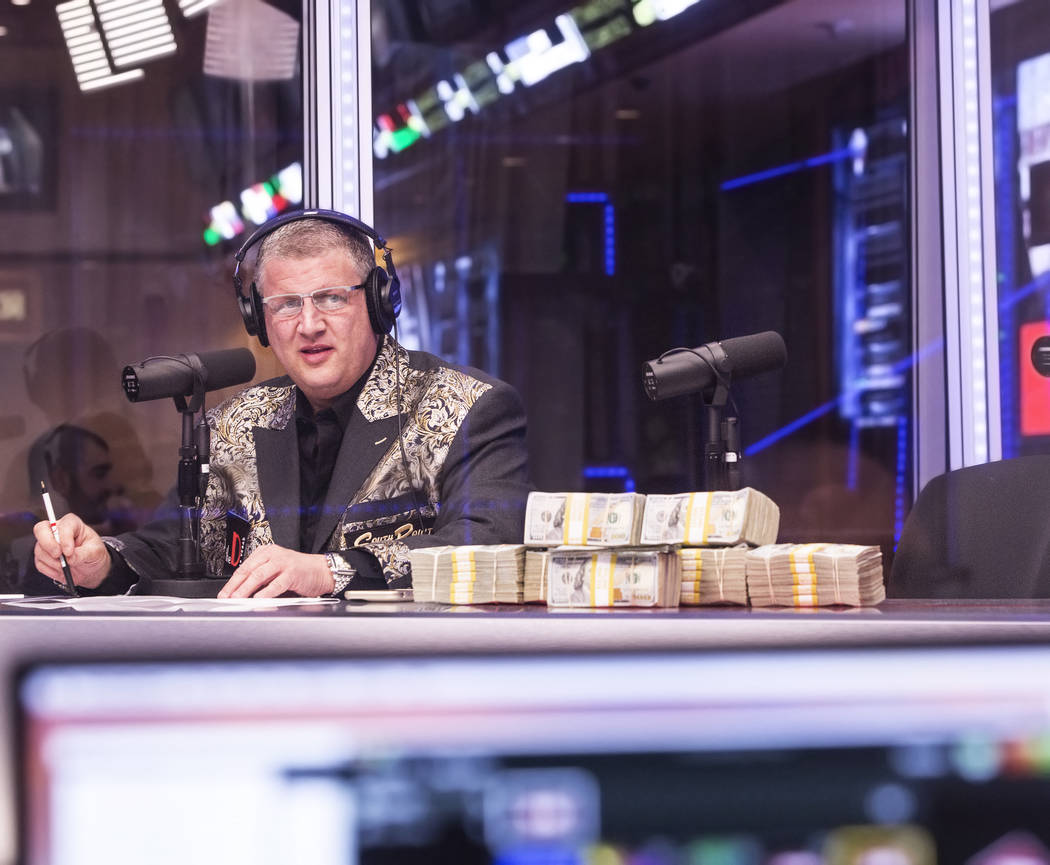 Derek Stevens, owner of the D Las Vegas hotel-casino, watches opening round lines come in during a live broadcast covering the NCCA Tournament on the Vegas Stats & Information Network on Sunda ...