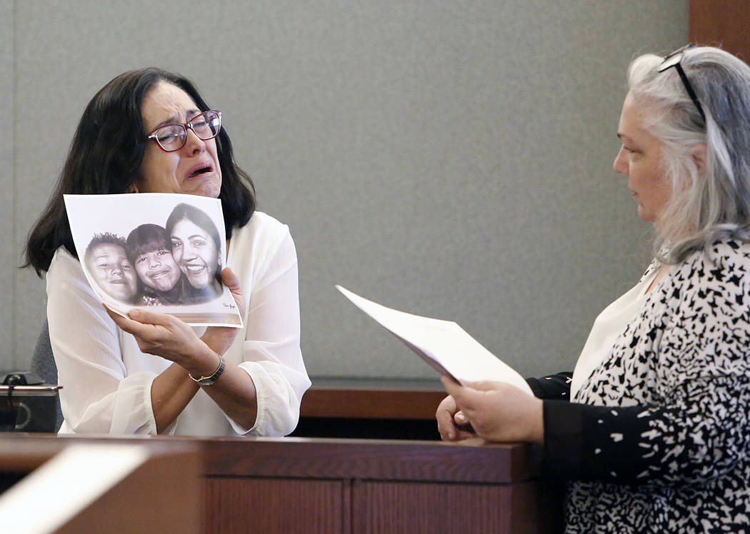 Martha Righetti, left, mother of Javier Righetti, gets emotional as she displays a picture of her children while testifying during the penalty phase of her son's murder trial at the Regional Justi ...