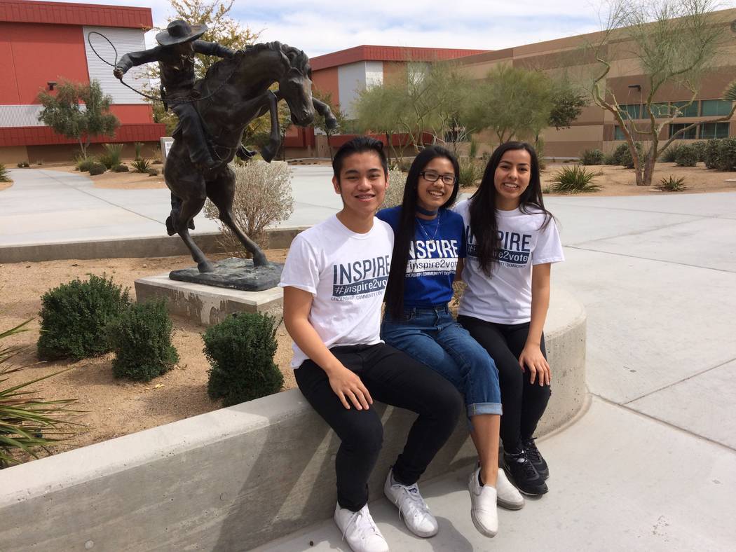 Jon Andre Parilla, Crysty-Ann Olaco and Ambika Verma, from left, talk March 10 about signing up fellow students to vote as they sit in the courtyard at West Career and Technical Academy, 11945 W.  ...