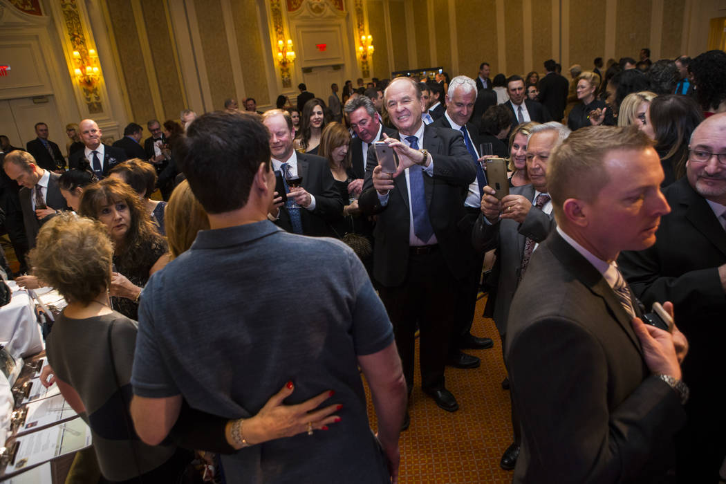 Attendees take photos with entrepreneur Mark Cuban during the Adelson Educational Campus' 13th annual In Pursuit of Excellence Gala at The Venetian hotel-casino in Las Vegas on Sunday, March 26, 2 ...