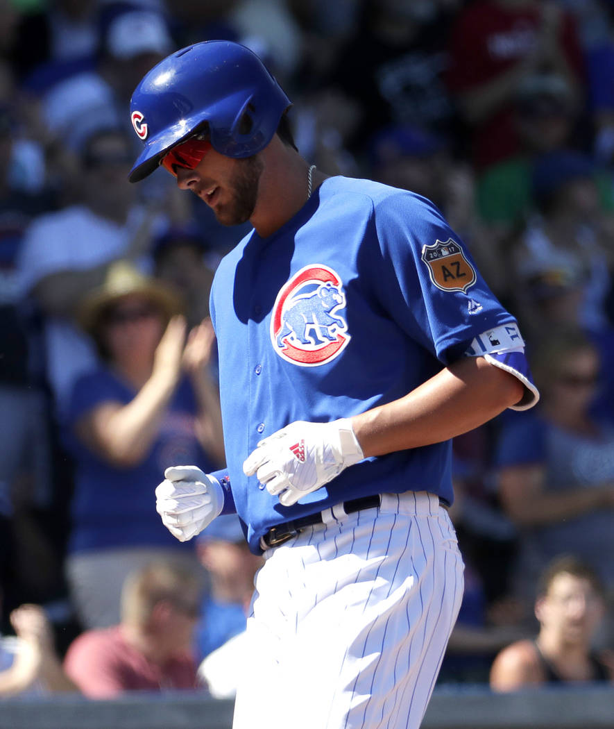 Chicago Cubs' Kris Bryant scores after hitting a solo home run against the Milwaukee Brewers during the first inning of a spring training baseball game, Tuesday, March 14, 2017, in Mesa, Ariz. (AP ...