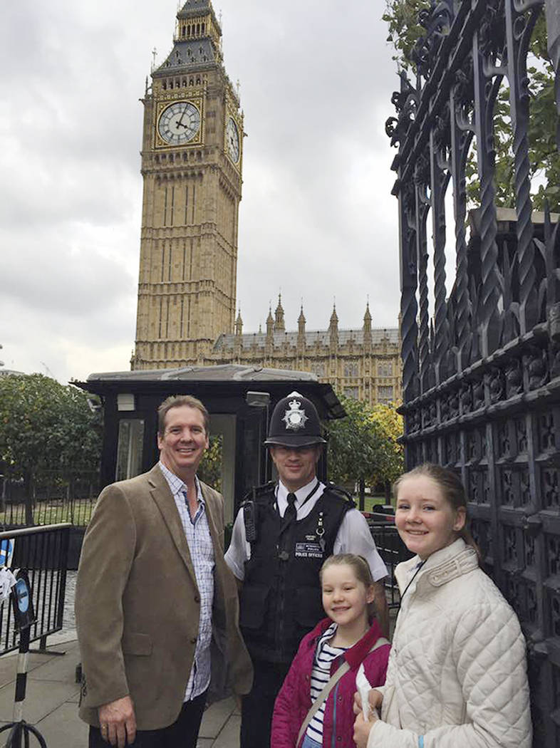 In this Oct. 14, 2016, image provided by Claire Thorogood, Andrew Thorogood, left, and his daughters, Alexsandra, second right, and Georgia, right, smile next to Officer Keith Palmer, second left, ...
