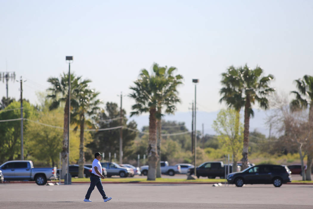 A man walks across a parking lot at Sunset Park in Las Vegas on Friday, March 24, 2017. (Brett Le Blanc/Las Vegas Review-Journal) @bleblancphoto