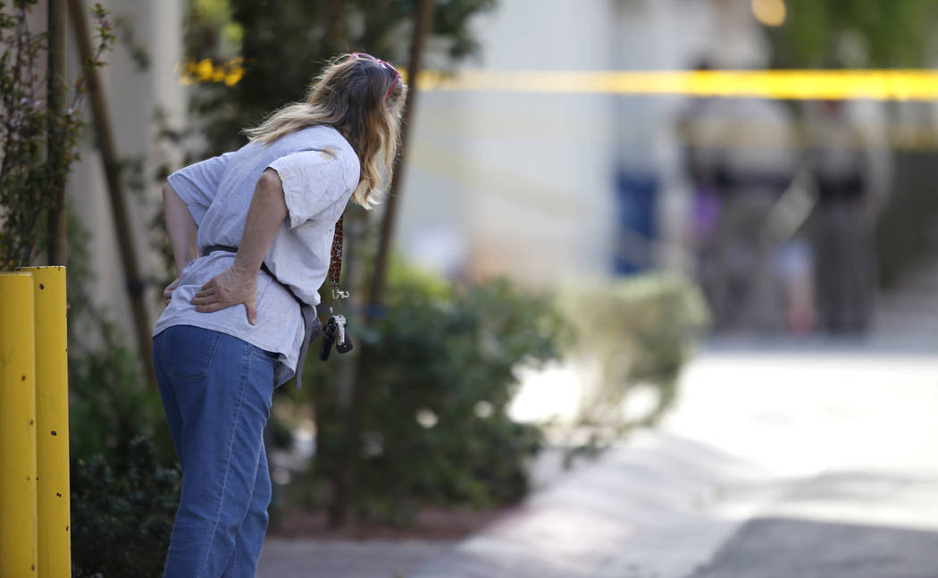 A neighbor near the 10200 block of Yarmouth Sea Ct. looks at a scene where Las Vegas Metropolitan police officers investigate a shooting on Friday, March 17, 2017, in Las Vegas. (Christian K. Lee/ ...