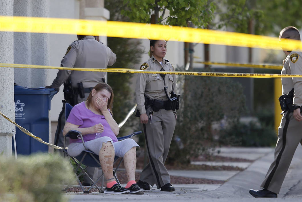 A woman reacts while Las Vegas police officers investigate a shooting near the 10200 block of Yarmouth Sea Ct. on Friday, March 17, 2017, in Las Vegas. (Christian K. Lee/Las Vegas Review-Journal)  ...