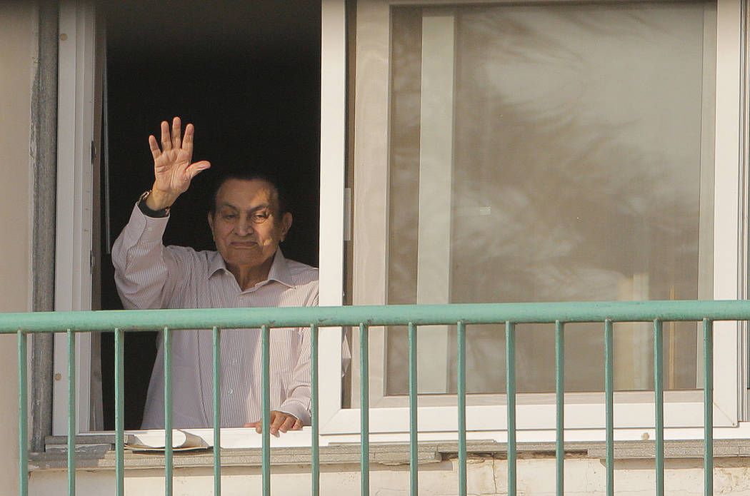 Ousted Egyptian President Hosni Mubarak waves to his supporters from his room at the Maadi Military Hospital as they celebrate the 43rd anniversary of the Oct. 6, 1973 war, Oct. 16, 1016. (Amr Nab ...