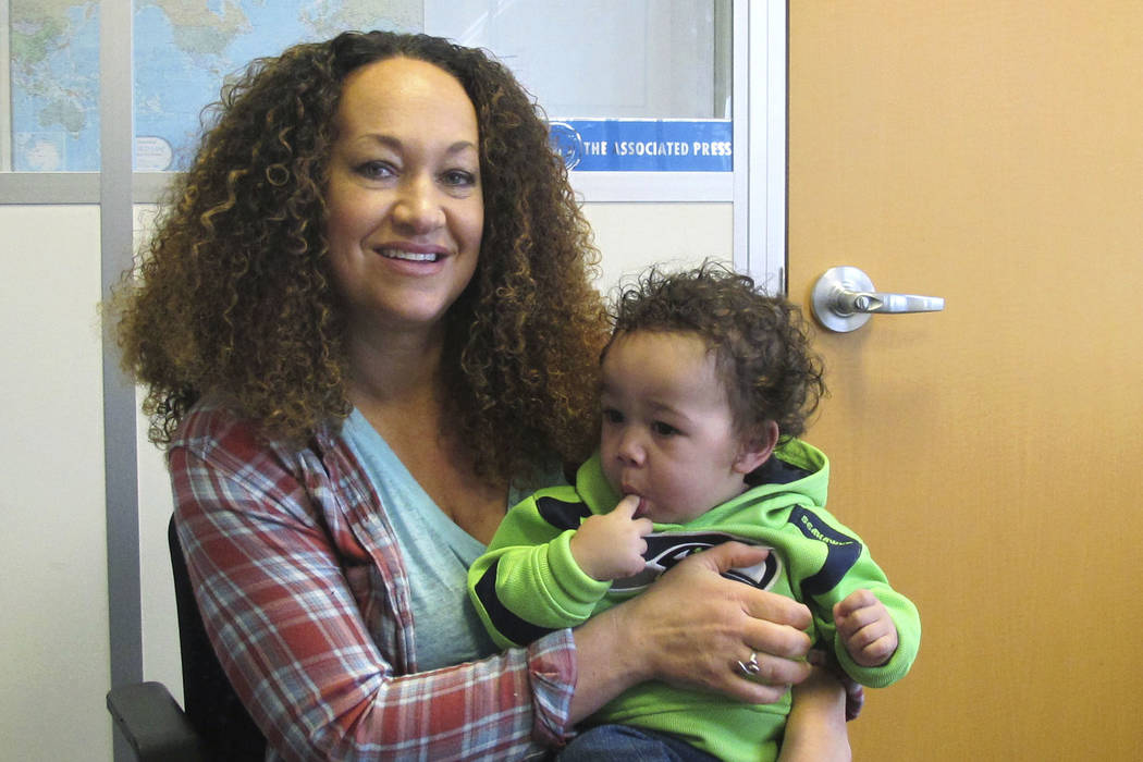 Rachel Dolezal poses for a photo with her son, Langston in the bureau of the Associated Press in Spokane, Wash. Dolezal, who has legally changed her name to Nkechi Amare Diallo, rose to prominence ...