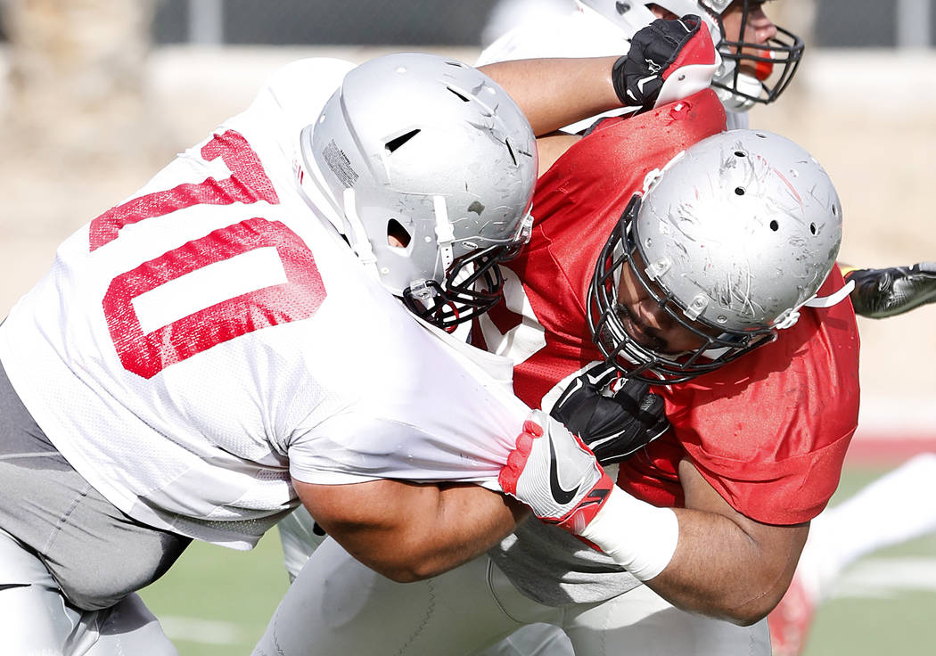 UNLV Rebels defensive line Jason Fao, right, defends offensive line Sid Acosta (70) during team's practice on Monday, March 20, 2017, in Las Vegas. (Bizuayehu Tesfaye/Las Vegas Review-Journal) @bi ...