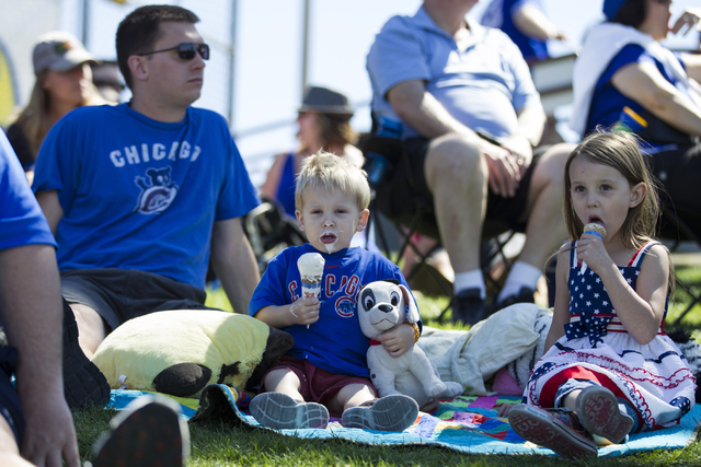 Andy Lenell, from left, and his children David, 2, and Selah, 5, watch the Chicago Cubs play against the New York Mets in their baseball game during Big League Weekend at Cashman Field on Friday,  ...