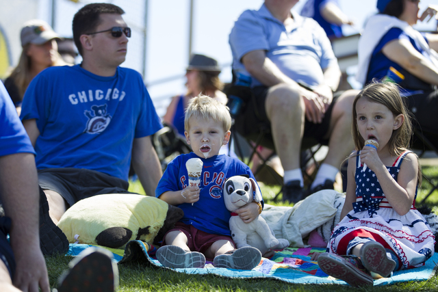 Andy Lenell, from left, and his children David, 2, and Selah, 5, watch the Chicago Cubs play against the New York Mets in their baseball game during Big League Weekend at Cashman Field on Friday, ...