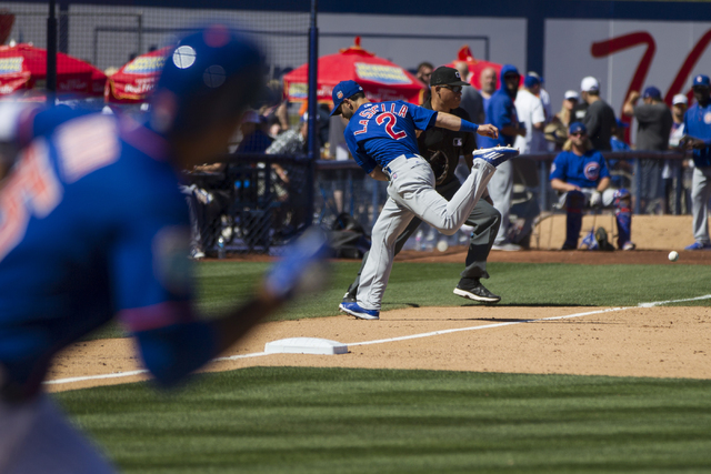 Chicago Cubs Tommy La Stella (2) is late to the ball for a New York Mets single in their baseball game during Big League Weekend at Cashman Field on Friday, April 1, 2016, in Las Vegas. The Mets w ...