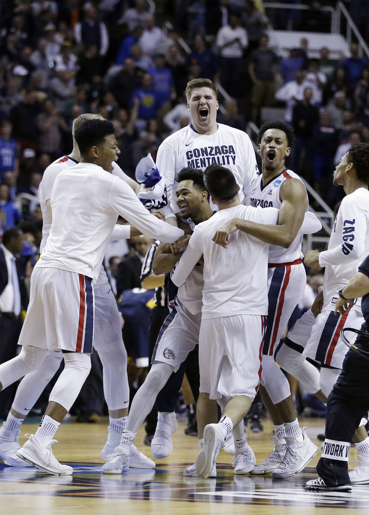 Gonzaga players celebrate after beating West Virginia during an NCAA Tournament college basketball regional semifinal game Thursday, March 23, 2017, in San Jose, Calif. (AP Photo/Ben Margot)