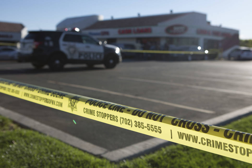 A police line borders a parking lot outside a Rapid Cash, on W. Flamingo Road near Jones Boulevard, where the incident took place in Las Vegas on Friday, March 24, 2017. (Bridget Bennett/Las Vegas ...