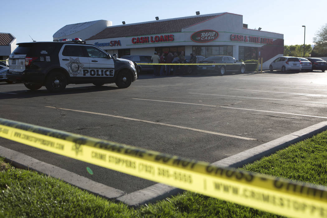A police line borders a parking lot outside a Rapid Cash, on W. Flamingo Road near Jones Boulevard, where the incident took place in Las Vegas on Friday, March 24, 2017. (Bridget Bennett/Las Vegas ...