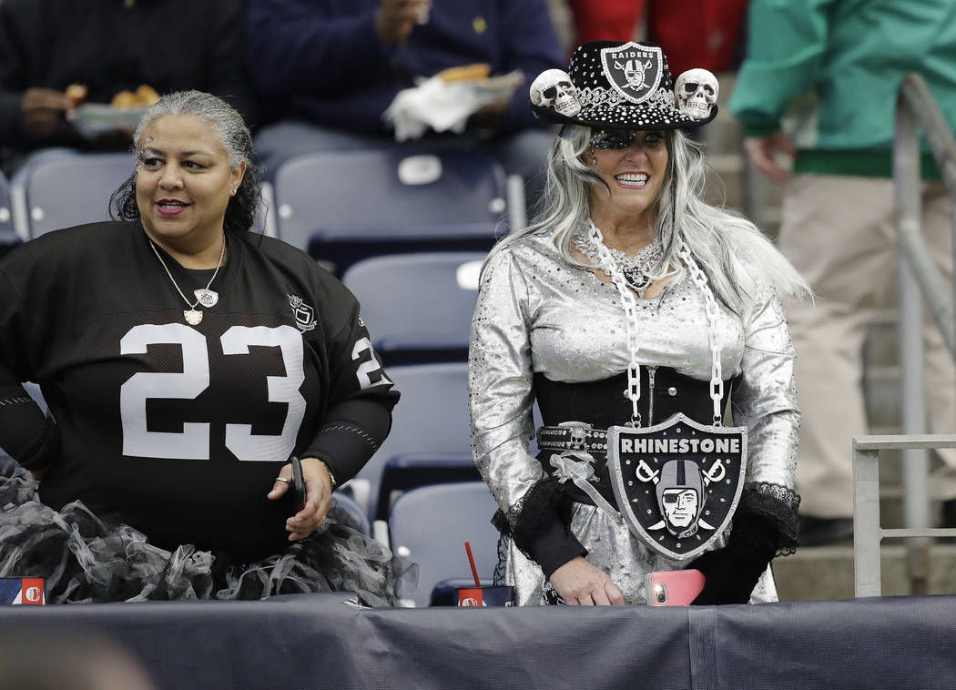 Oakland Raiders fans watch teams warm up before the first half of an AFC Wild Card NFL football game between the Houston Texans and the Oakland Raiders, Saturday, Jan. 7, 2017, in Houston. (Eric G ...