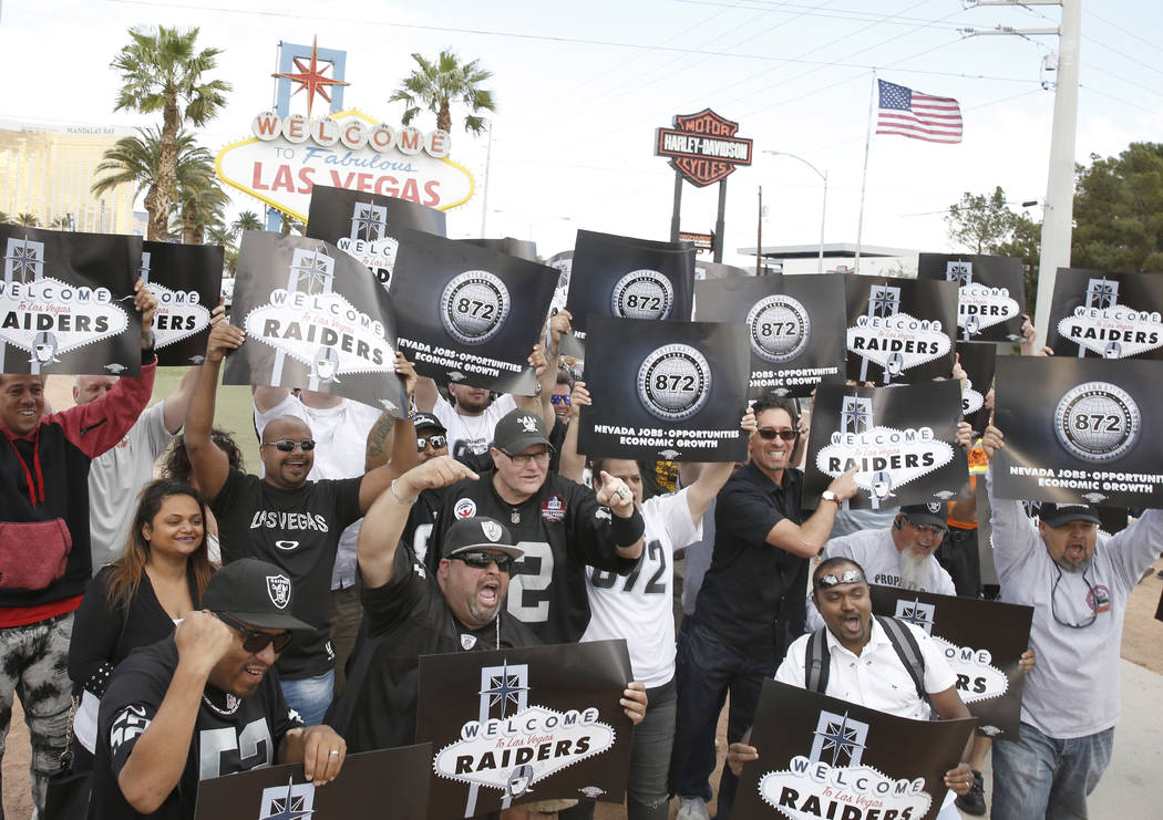 Raiders fans celebrate in Las Vegas after the National Football League owners voted in Phoenix to approve the relocation of the Oakland Raiders to Las Vegas on Monday, 27, 2017. (Bizuayehu Tesfaye ...