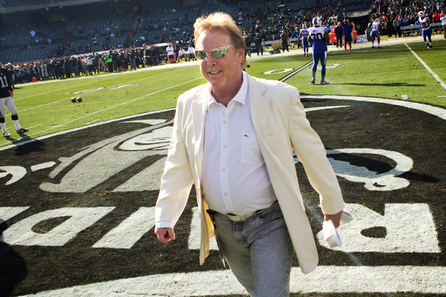 Mark Davis, owner and managing general partner of the Oakland Raiders, talks to current and former players and coaches as he walks around the stadium prior to a game at Oakland Colosseum, Sunday,  ...