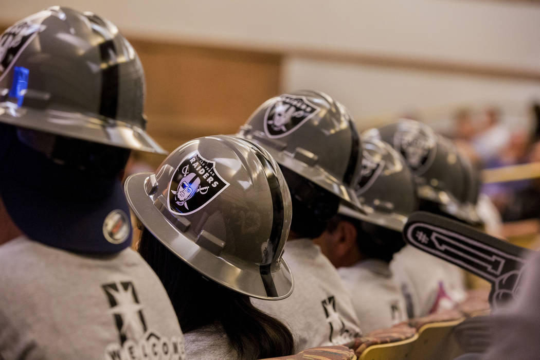 Union workers dress in Las Vegas Raider attire during a Las Vegas Stadium Authority meeting on the status of lease agreement negotiations with the Oakland Raiders at the Clark County Government Ce ...