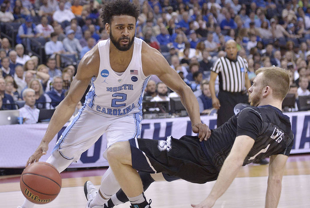 North Carolina guard Joel Berry II (2) moves past Butler guard Tyler Lewis in the first half of an NCAA college basketball tournament South Regional semifinal game Friday, March 24, 2017, in Memph ...