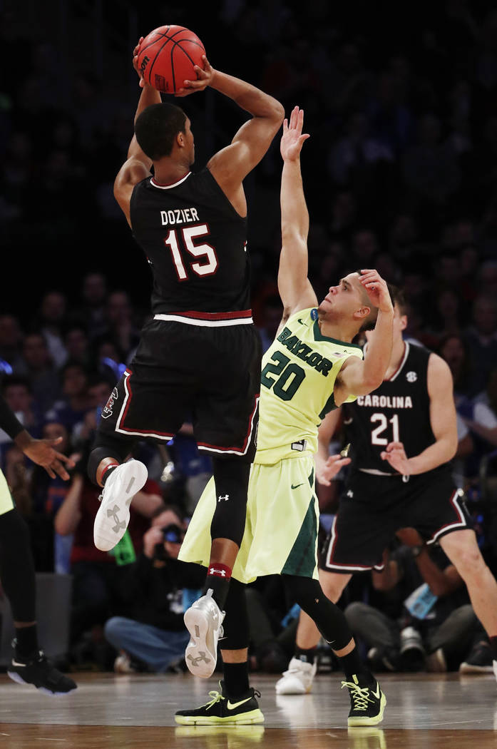 South Carolina guard PJ Dozier (15) puts up a shot against Baylor guard Manu Lecomte (20) in the second half of an East Regional semifinal game of the NCAA men's college basketball tournament, Fri ...