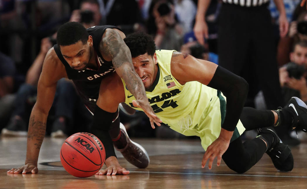 South Carolina guard Sindarius Thornwell (0) and Baylor guard Ishmail Wainright (24) scramble for a loose ball in the second half of an East Regional semifinal game of the NCAA men's college baske ...