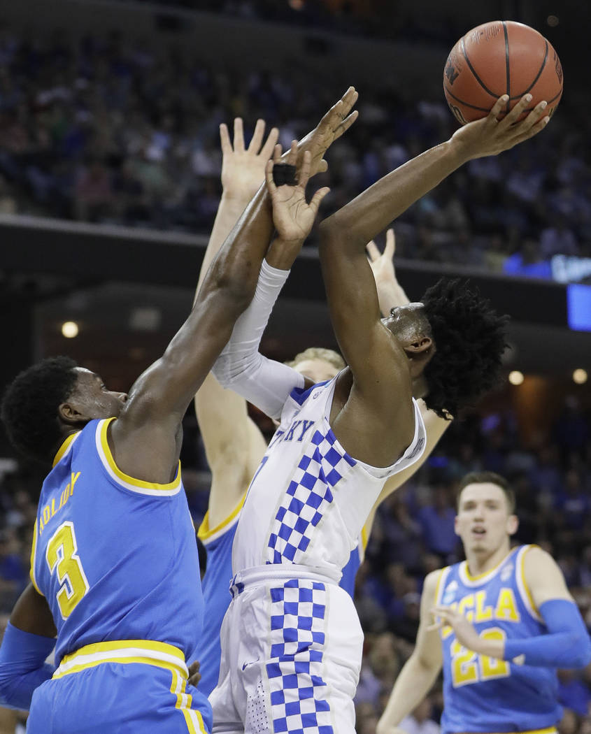 Kentucky guard De'Aaron Fox shoots against UCLA guard Aaron Holiday in the first half of an NCAA college basketball tournament South Regional semifinal game Friday, March 24, 2017, in Memphis, Ten ...